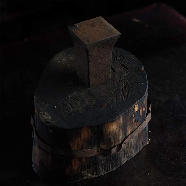 Anvil and wooden stand