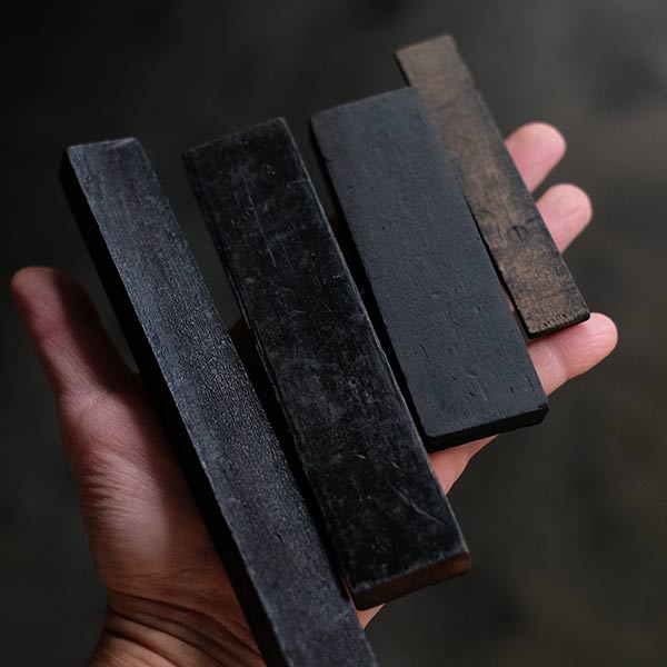 A set of black sticks used in a factory
