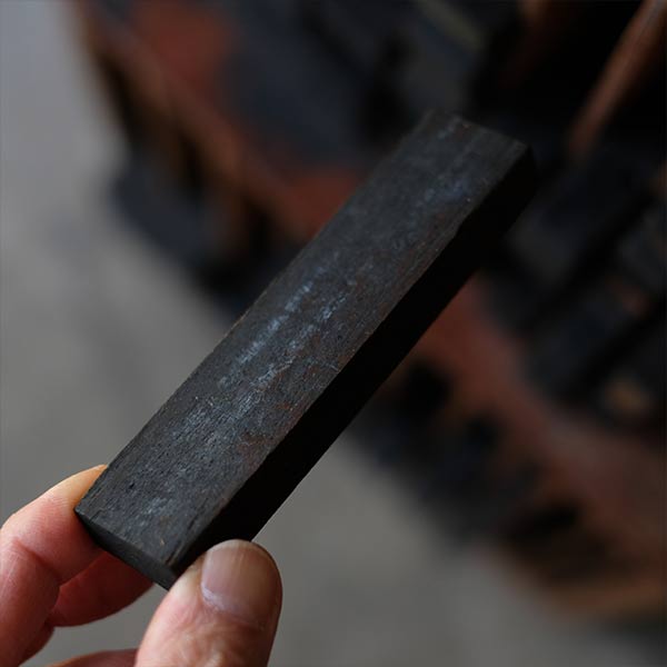 A set of black sticks used in a factory