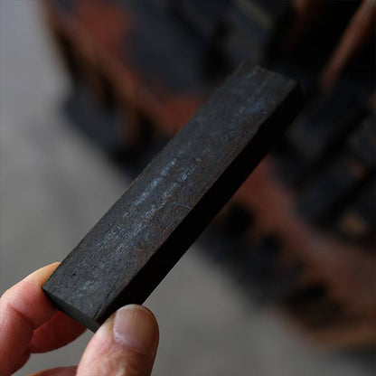 A set of black sticks used in a factory
