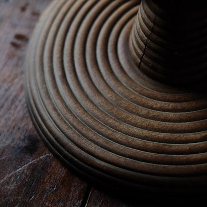 A distorted Showa-era electric fan stand