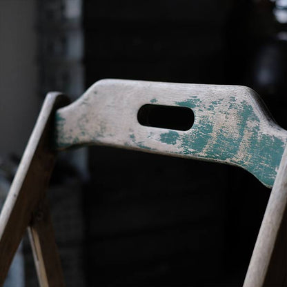 Folding chair with peeling paint