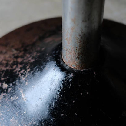 A swivel stool with rusty iron legs