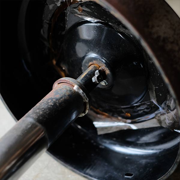 A swivel stool with rusty iron legs