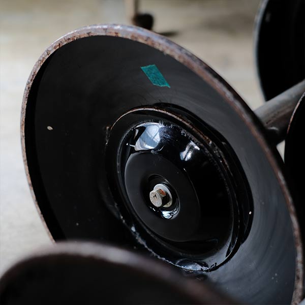 A swivel stool with rusty iron legs
