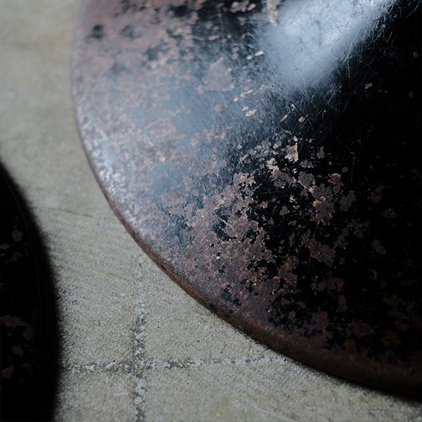 A swivel stool with rusty iron legs