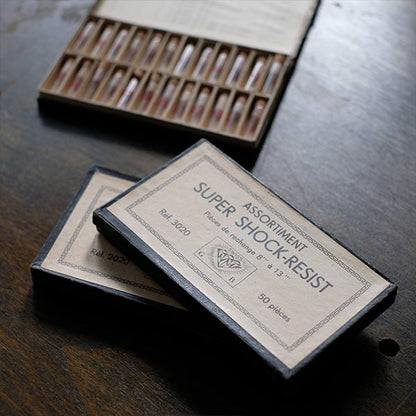 A set of small jars containing mechanical watch parts