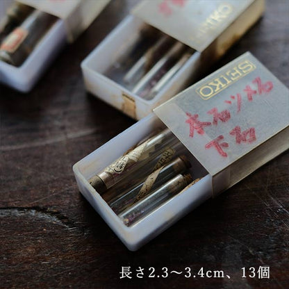 Cans and bottles containing watch parts (85 cans, 85 bottles)