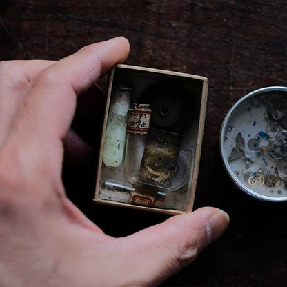 Cans and bottles containing watch parts (85 cans, 85 bottles)